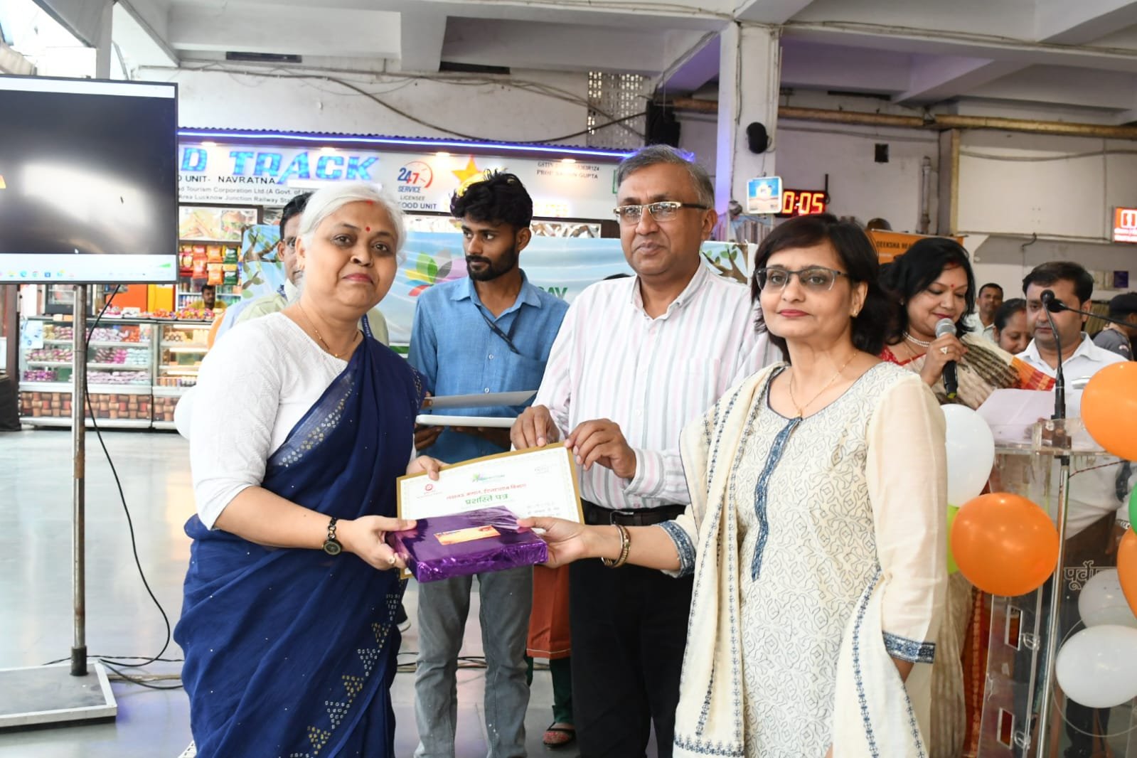 मंरेप्र गौरव अग्रवाल ऐशबाग जं0 स्टेशन पर रेलकर्मियों को उपहार प्रदान करते हुए